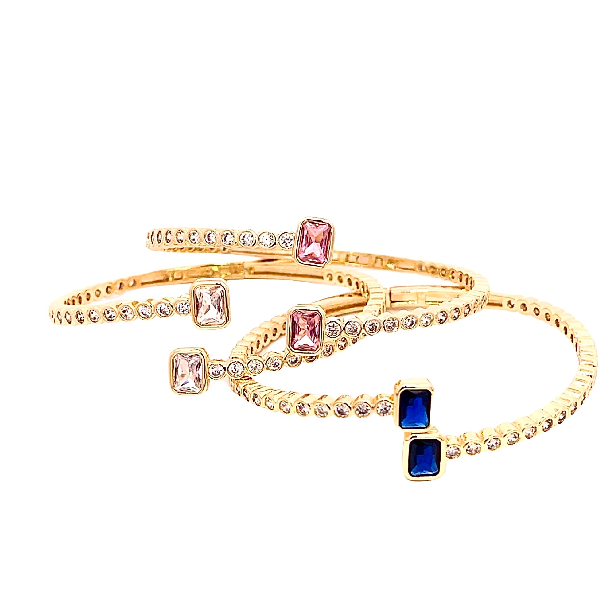 Close-up gold open cuff bracelet featuring pink square stones and clear crystals